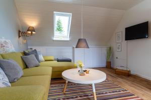 a living room with a couch and a table at Ferienwohnung-Elli in Garding