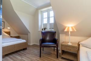 a bedroom with a bed and a chair and a window at Haus-Molina in Böhl