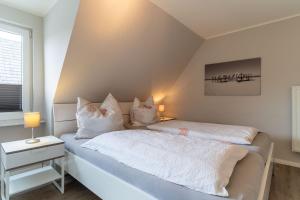 a bedroom with two beds with white sheets and pillows at Duenenzauber in Olsdorf