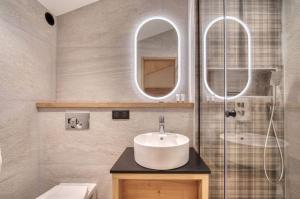 a bathroom with a sink and a glass shower at Appartement 123 (RDP) in Tignes +18 photos