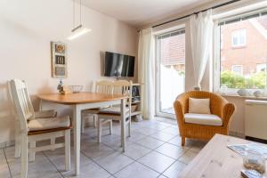 a kitchen and dining room with a table and chairs at Strandglueck in Westereck +7 photos