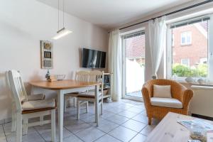 a kitchen and dining room with a table and chairs at Strandglueck in Westereck