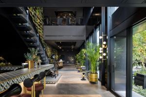 a lobby of a building with plants on the walls at Mercure Tokyu Stay Osaka Namba in Osaka