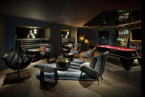 a living room with a pool table and a billiard room at Mercure Tokyu Stay Osaka Namba in Osaka