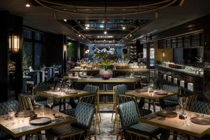 a restaurant with wooden tables and chairs and a bar at Mercure Tokyu Stay Osaka Namba in Osaka