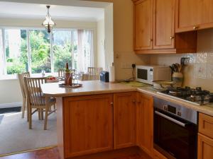 a kitchen with wooden cabinets and a counter top at Millside in Morpeth