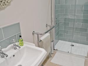 a bathroom with a sink and a shower at Abbeydale Town House in Whitby