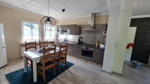 a kitchen with a table and chairs in a room at Ferienwohnung Ollywood, Natur pur im Westerwald, 2 bis 4 Personen 