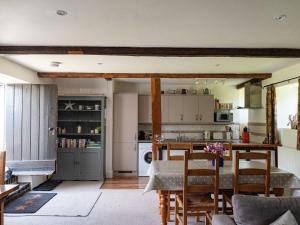 a kitchen with a table and chairs in a room at Old Orchard Cottage in Haydon