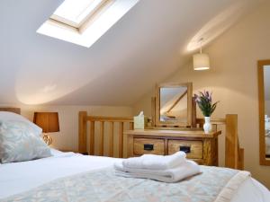 a bedroom with a bed and a mirror at Shepherds Lodge in Lamphey