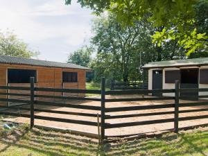 a wooden fence in front of a house at Field Cottage in Sudbourne