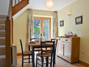 a dining room with a table and chairs and a window at Hope Cottage in Knighton