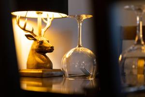 a trophy deer head next to a lamp on a table at The Ancient Unicorn in Barnard Castle