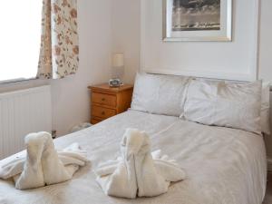 a bedroom with white towels on a bed at Dart Corner in Bovey Tracey