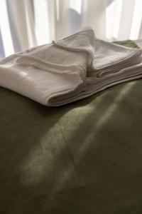 a white towel sitting on top of a bed at Hotel 1700 in Bakuriani