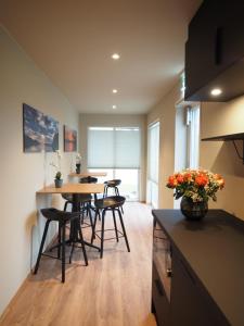 a kitchen with a table and chairs in a room at Hotell Skolestua in Lund