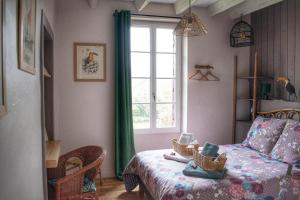 a bedroom with a bed and a window at Les Volets Violets in Salles