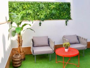 two chairs and a table on a patio at Tennessee Urban Suites in Málaga