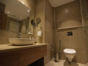 a bathroom with a sink and a toilet at Clarks Inn Express, Dehradun in Dehradun