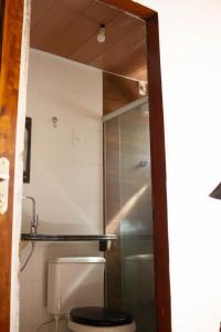 a bathroom with a toilet and a shower at Verano House BF in Baía Formosa