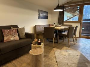 a living room with a couch and a table at Klausnerhof in Aschau