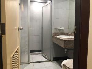 a bathroom with a shower and a sink at Floral Shire Suvarnabhumi Airport - SHA Extra Plus in Lat Krabang