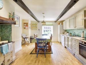 a kitchen with a table and chairs and a dining room at Carriage House - E5119 in West Burton