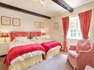 a bedroom with a bed and a chair and a window at Carriage House - E5119 in West Burton