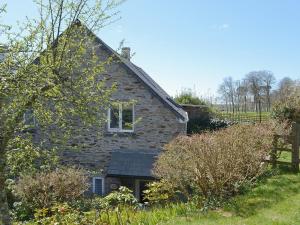 a stone house with a window on the side of it at Coach House in Loddiswell