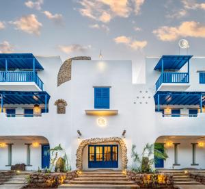 a white building with blue doors and stairs at Conch Resort Luxury Private Pool Suites in Puducherry
