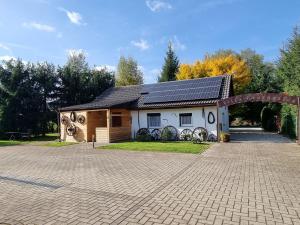 a house with solar panels on top of it at Villa Fantastica Apartments in Mysłakowice