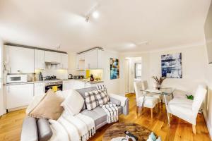 a living room with a couch and a table at Park Lane Apartments Marble Arch in London