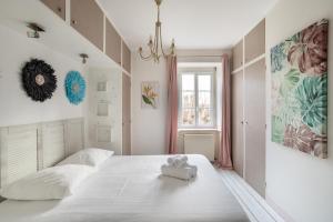 ein Schlafzimmer mit einem weißen Bett mit einem ausgestopften Tier darauf in der Unterkunft Le Routhouan - Idéalement situé à Saint-Malo in Saint-Malo