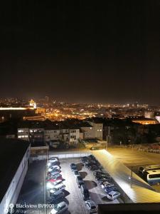 a parking lot filled with cars at night at Oporto apartment Batalha in Porto