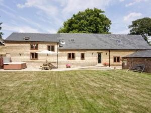 a large wooden house with a large yard at Cefnaire Isaf in Newtown