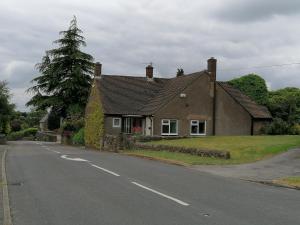 a house sitting on the side of a road at The Bungalow in Pentrich