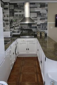 a kitchen with white cabinets and a stove at Casa en Castanedo: Casa El Solarón in Castanedo