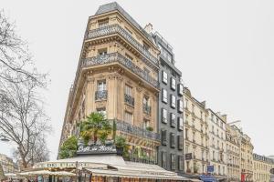 a tall building with a clock tower on top of it at Sublime Suite à saint Germain des Près (Montana 7) in Paris