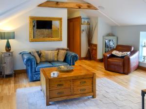 a living room with a couch and a coffee table at Alnwick Loft in Alnwick