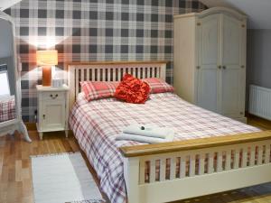 a bedroom with a bed with a red bow on it at Alnwick Loft in Alnwick
