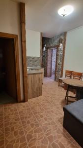 a living room with a kitchen and a table and a table at Pirin Studios in Bansko