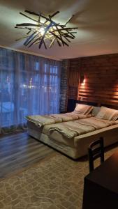 a bedroom with two beds and a chandelier at Pirin Studios in Bansko