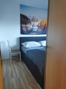 a small bedroom with a bed and a table at Haus Knoll in Imsterberg