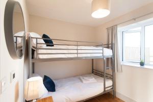 a bunk bed room with two bunk beds and a mirror at The Parlour in Cricklade