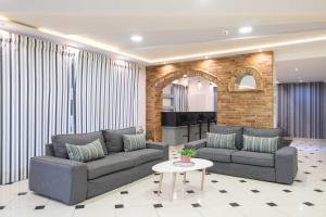 a living room with two couches and a table at Karras Hotel in Laganas