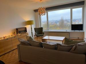 a living room with a couch and a table at 2 bedroom appartement in Antwerp, with amazing view in Antwerp