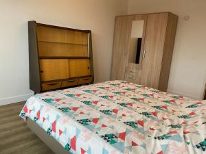 a bedroom with a large bed and a wooden cabinet at 2 bedroom appartement in Antwerp, with amazing view in Antwerp