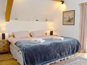 a bedroom with a bed with two towels on it at The Granary - Hkkw in Lynton