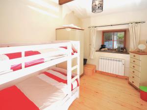 a bedroom with two bunk beds and a window at Bramble Cottage - 27978 in Whalley