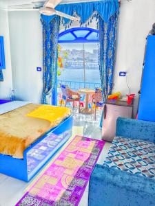 a bedroom with two beds and a table and chairs at Airkela Nuba Dool2 in Aswan